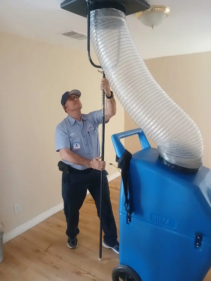 Furnace Tune-Up technician using HEPA equipment in Leesville